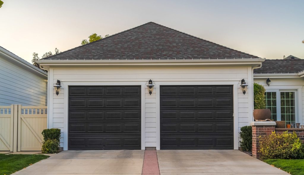 house with two black garage doors